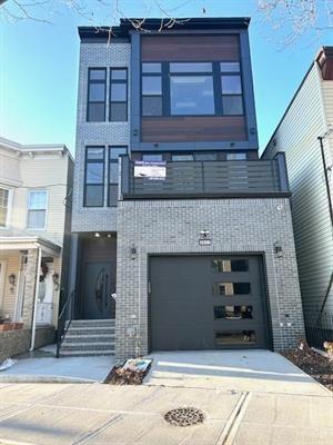 3611 John F Kennedy Blvd Unit 2, Jersey City, NJ 07307 - contemporary house featuring brick siding, a garage, and concrete driveway