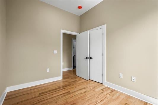 3611 John F Kennedy Blvd Unit 2, Jersey City, NJ 07307 - unfurnished bedroom featuring light wood-style flooring, baseboards, and a closet