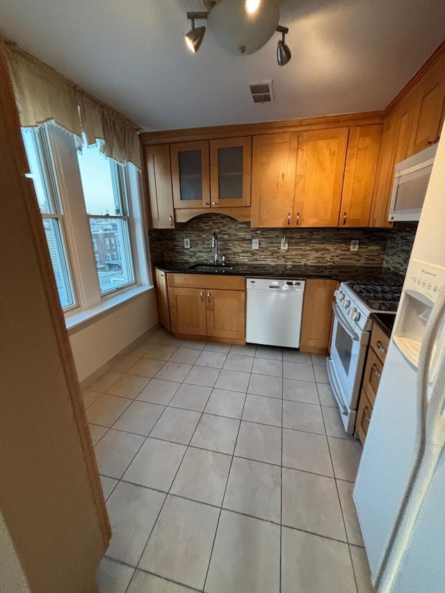 3444 John F Kennedy Blvd Unit 4F, Jersey City, NJ 07307 - kitchen with white appliances, light tile patterned flooring, tasteful backsplash, and brown cabinetry