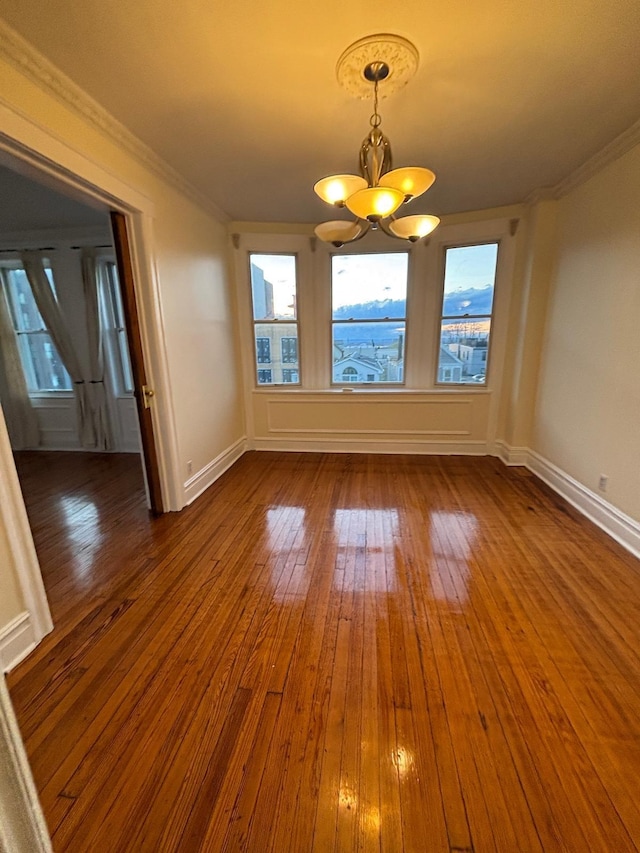 3444 John F Kennedy Blvd Unit 4F, Jersey City, NJ 07307 - unfurnished dining area featuring a chandelier, wood-type flooring, plenty of natural light, baseboards, and crown molding