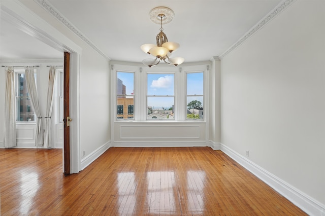 3444 John F Kennedy Blvd Unit 4F, Jersey City, NJ 07307 - unfurnished dining area with a chandelier, light wood finished floors, crown molding, and baseboards