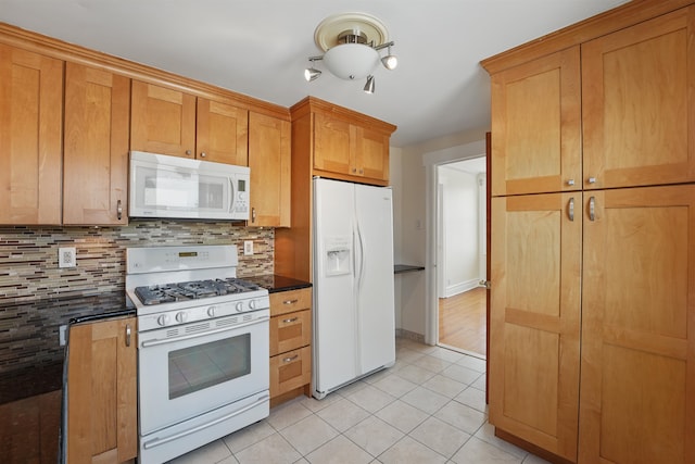 3444 John F Kennedy Blvd Unit 4F, Jersey City, NJ 07307 - kitchen featuring white appliances, dark countertops, light tile patterned flooring, and decorative backsplash
