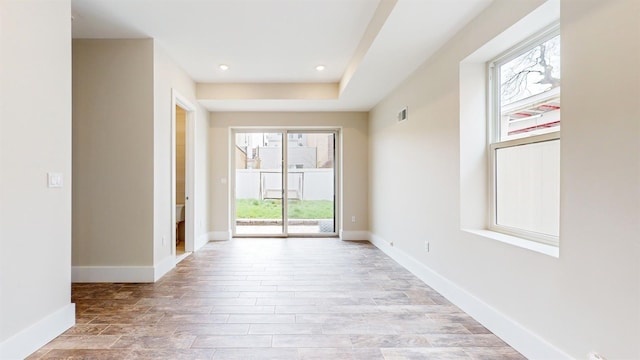 interior space featuring baseboards, light wood finished floors, and recessed lighting