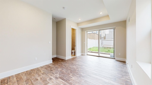 empty room with baseboards, light wood-style floors, and recessed lighting