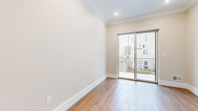 unfurnished room featuring recessed lighting, ornamental molding, baseboards, visible vents, and wood finished floors