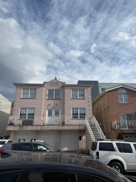 townhome / multi-family property featuring a garage and brick siding