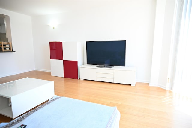 20 2nd St Unit 2111, Jersey City, NJ 07034 - living area featuring wood finished floors and baseboards