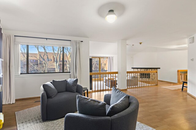 living room featuring baseboards and light wood-style floors