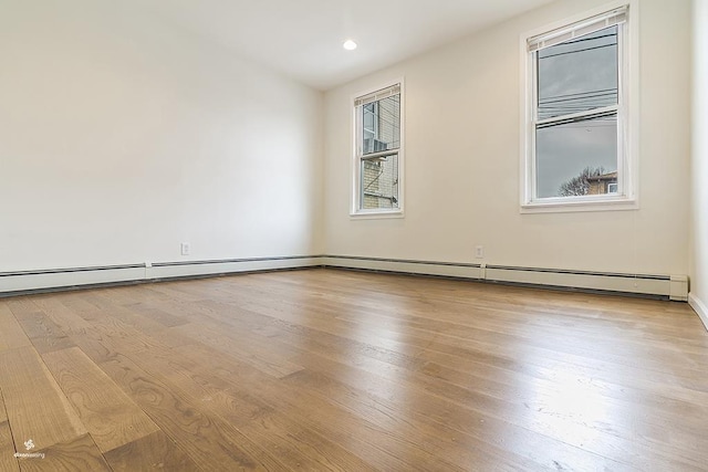 72 W 22nd St, Bayonne, NJ 07002 - spare room with wood finished floors, plenty of natural light, recessed lighting, and baseboards