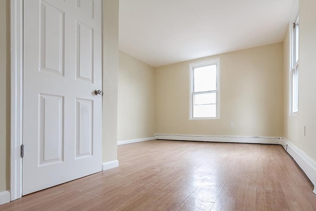 72 W 22nd St, Bayonne, NJ 07002 - spare room with light wood-style floors, baseboards, and a baseboard radiator