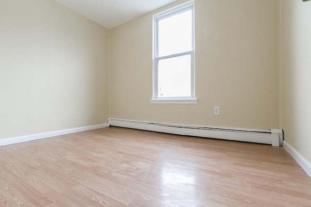 72 W 22nd St, Bayonne, NJ 07002 - spare room featuring light wood-style floors, a baseboard heating unit, and baseboards