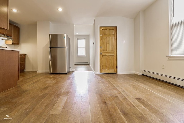 72 W 22nd St, Bayonne, NJ 07002 - kitchen featuring freestanding refrigerator, light wood-style flooring, baseboard heating, baseboards, and light countertops