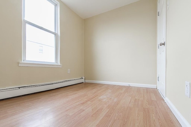 72 W 22nd St, Bayonne, NJ 07002 - unfurnished room with light wood-type flooring, a baseboard heating unit, and baseboards