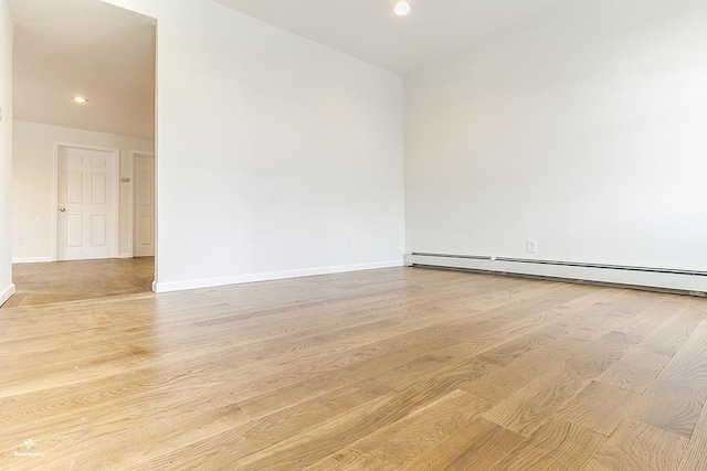 72 W 22nd St, Bayonne, NJ 07002 - spare room with light wood-type flooring, baseboards, a baseboard radiator, and recessed lighting