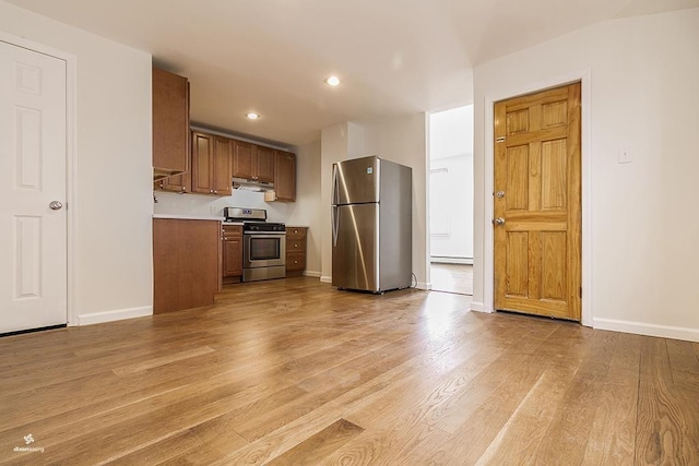 72 W 22nd St, Bayonne, NJ 07002 - kitchen with stainless steel appliances, light countertops, light wood-style floors, baseboards, and brown cabinetry