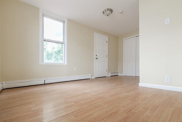 72 W 22nd St, Bayonne, NJ 07002 - spare room with light wood-style floors, a baseboard heating unit, and baseboards