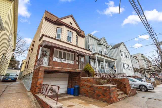 multi unit property featuring a porch and a garage