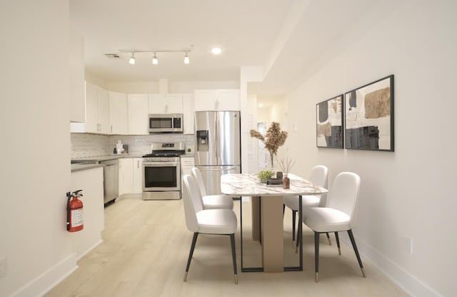 107 Laidlaw Ave Unit 2, Jersey City, NJ 07306 - dining space featuring baseboards and light wood-style flooring
