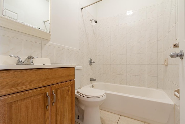 full bathroom featuring tile patterned floors, toilet, tile walls, tiled shower / bath, and vanity