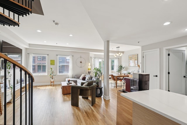 609 Jefferson St Unit 4D, Hoboken, NJ 07030 - living area with plenty of natural light, light wood finished floors, a chandelier, stairs, and recessed lighting