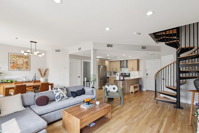 609 Jefferson St Unit 4D, Hoboken, NJ 07030 - living room featuring stairs, light wood-type flooring, a chandelier, and recessed lighting
