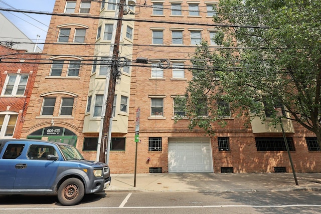 609 Jefferson St Unit 4D, Hoboken, NJ 07030 - view of building exterior featuring a garage