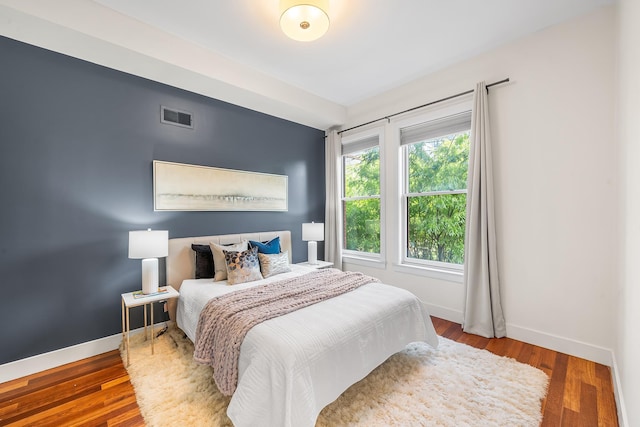 bedroom featuring baseboards and wood finished floors