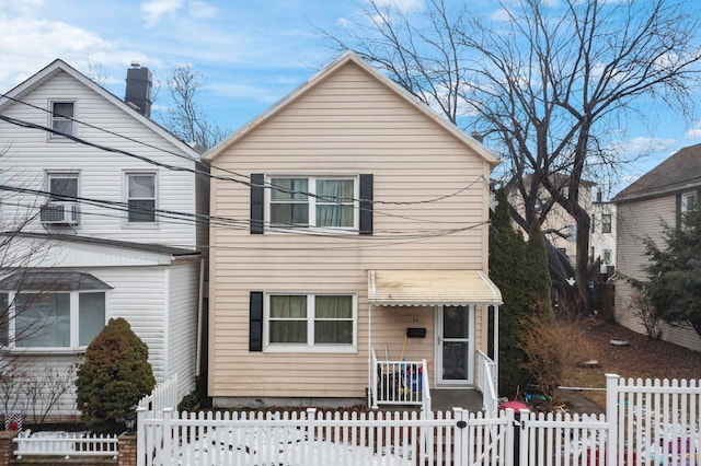 traditional-style house with a fenced front yard