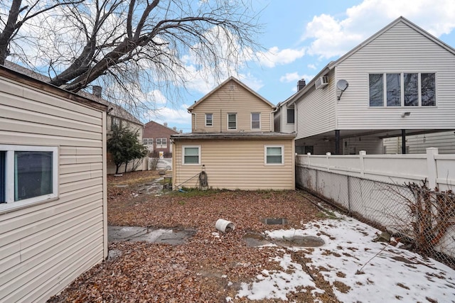 rear view of house with fence