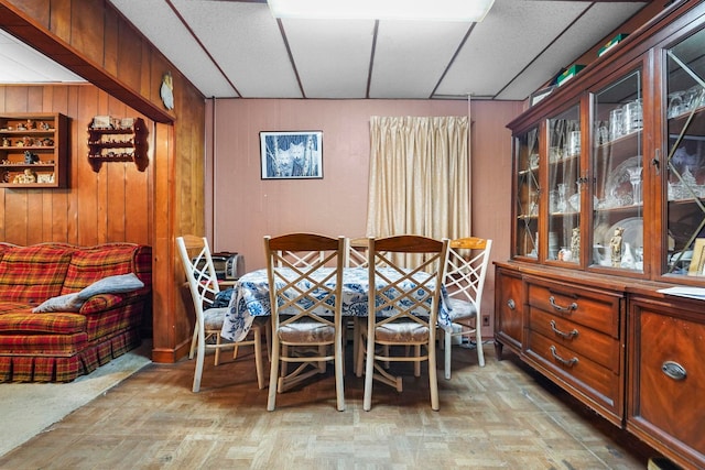 dining room with wooden walls