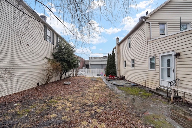 view of yard with entry steps and fence