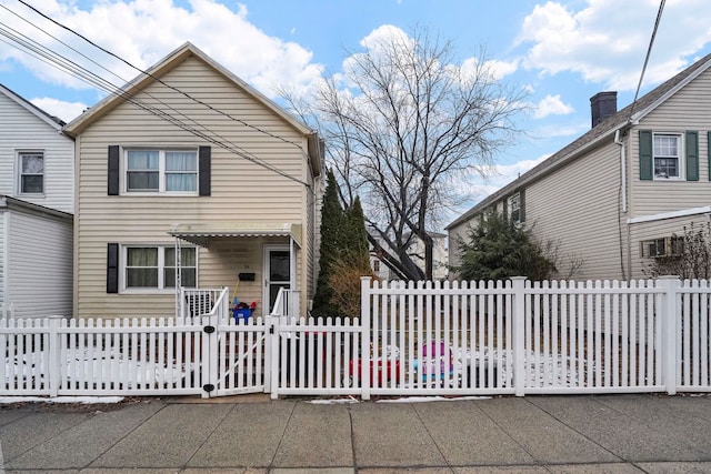 traditional-style house with a fenced front yard