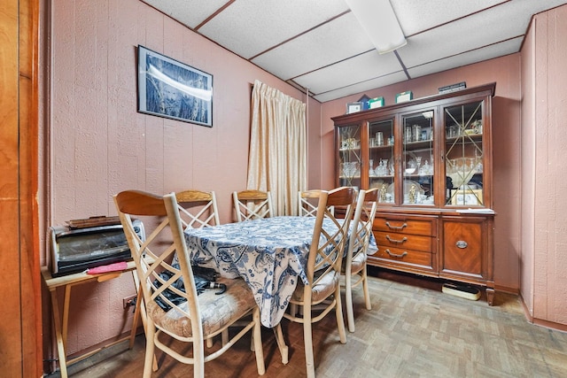 dining room with a drop ceiling