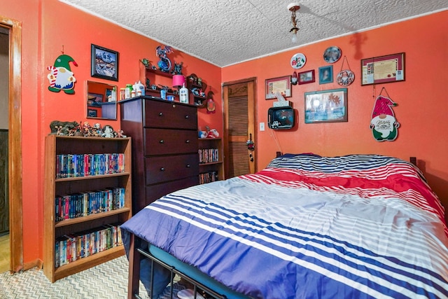 carpeted bedroom with a closet and a textured ceiling