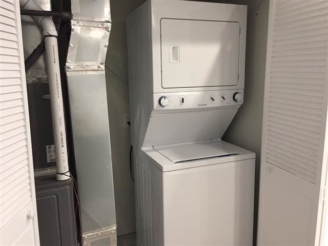 laundry area with stacked washer / drying machine