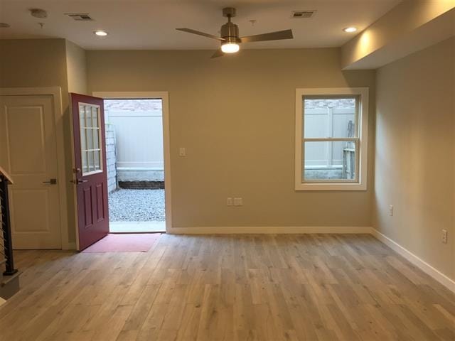 interior space with ceiling fan, plenty of natural light, and light hardwood / wood-style floors