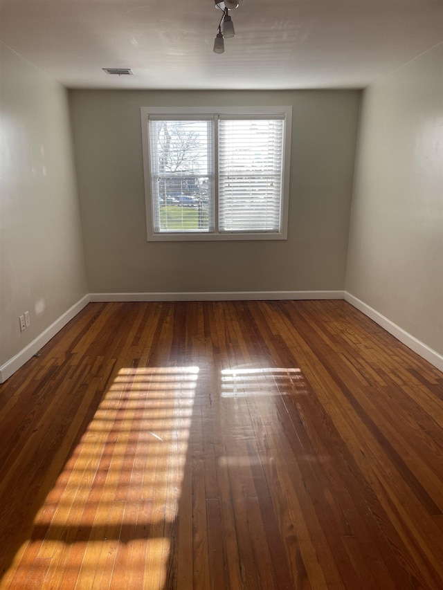 empty room with hardwood / wood-style floors