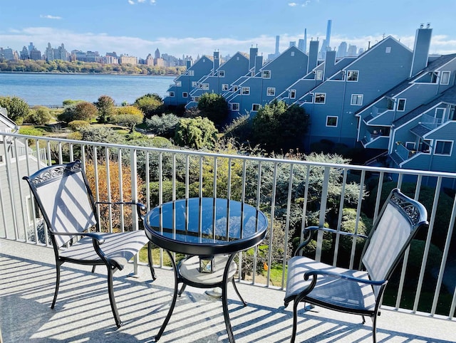 balcony featuring a view of city and a water view