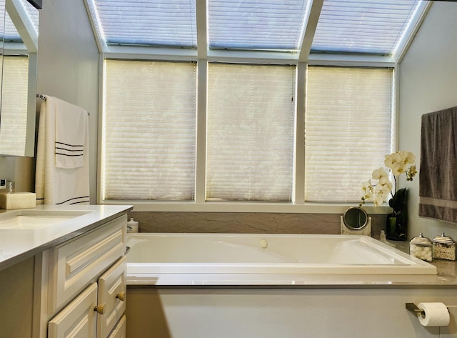 full bathroom featuring a bath and vanity