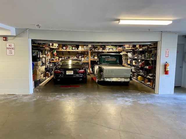 garage with a workshop area and concrete block wall