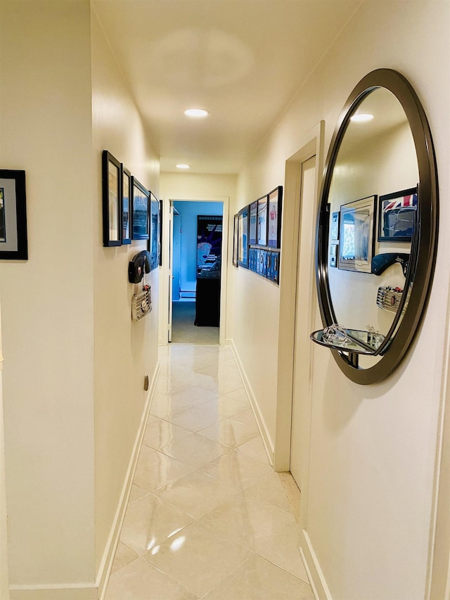 hallway with recessed lighting and baseboards