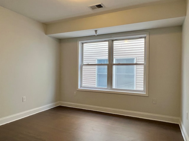 unfurnished room featuring dark hardwood / wood-style flooring