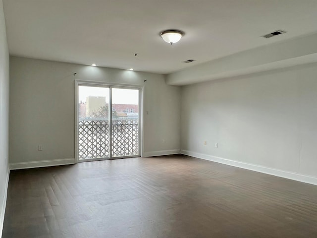 empty room featuring dark hardwood / wood-style flooring