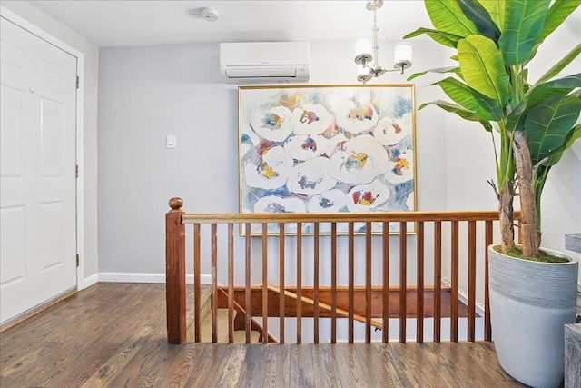 221 Terrace Ave, Jersey City, NJ 07307 - corridor with a wall mounted air conditioner, an upstairs landing, wood finished floors, a chandelier, and baseboards