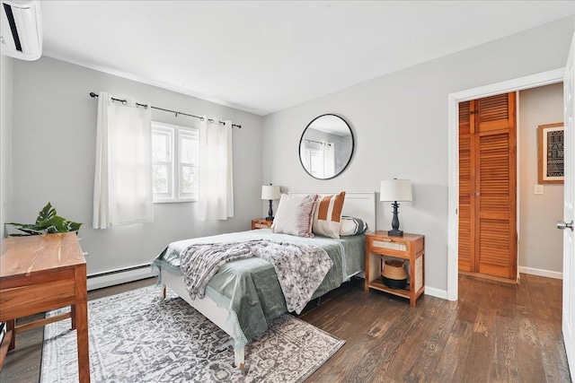 221 Terrace Ave, Jersey City, NJ 07307 - bedroom featuring a baseboard heating unit, wood finished floors, and baseboards