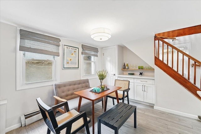 221 Terrace Ave, Jersey City, NJ 07307 - dining space featuring stairs, baseboards, light wood-style flooring, and a dry bar