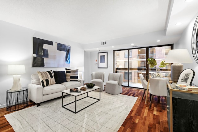 living room featuring recessed lighting, visible vents, and wood finished floors