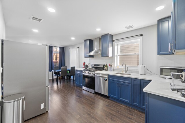 225 Freeman Ave, Jersey City, NJ 07306 - kitchen with visible vents, blue cabinetry, appliances with stainless steel finishes, wall chimney exhaust hood, and a sink