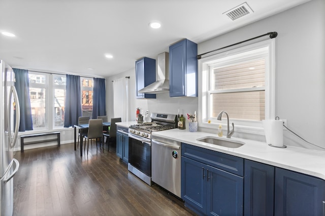 225 Freeman Ave, Jersey City, NJ 07306 - kitchen featuring stainless steel appliances, blue cabinets, wall chimney range hood, and a sink