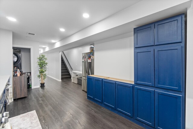 225 Freeman Ave, Jersey City, NJ 07306 - interior space with dark wood finished floors, stairway, recessed lighting, stacked washing maching and dryer, and freestanding refrigerator